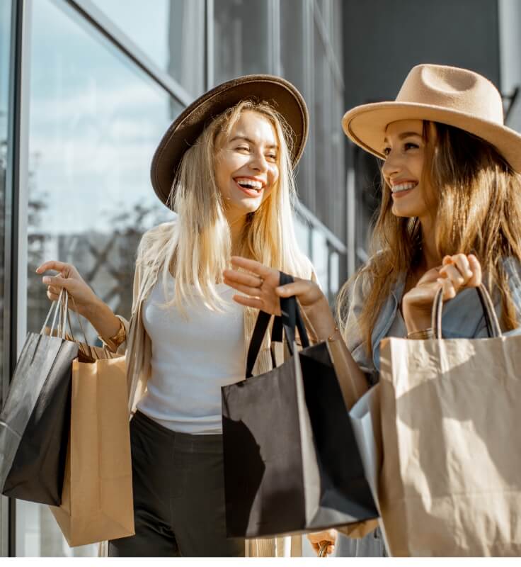 two women shopping and smiling